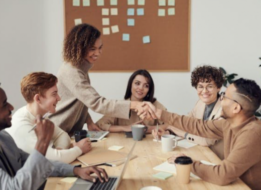 Group of Smiling Professional Women Sitting at a Conference Table